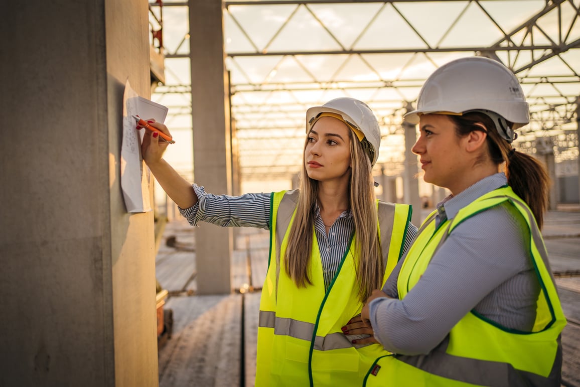 Female engineers overseeing construction site